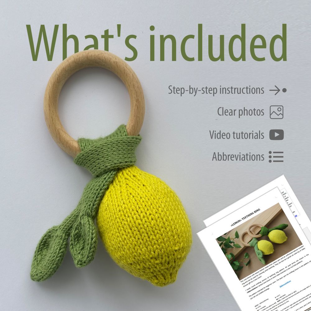 A knitted baby teether in the shape of a lemon, with knitting instructions placed nearby