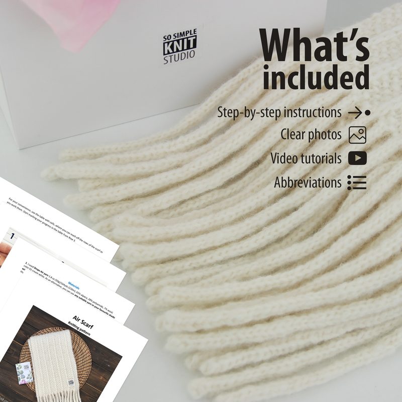 The image shows a partially unraveled light beige scarf with fringe details, lying on a white surface. In the background, there are printed pages featuring instructions for knitting, with clear photographs and text, arranged in a slightly fanned-out manner. A white box labeled "So Simple Knit Studio" is partially visible in the background, adding context to the knitting theme. The overall composition is clean and focuses on the scarf and instructional materials.