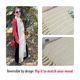 The image features a long, reversible knitted scarf displayed in a warm, cream color. The scarf has a textured pattern with fringes at both ends. In the background, a woman stands outdoors wearing a red leather jacket, black pants, and sunglasses, holding a red handbag. The scarf is shown in two close-up images at the bottom, highlighting its texture and the soft yarn used. The overall composition presents a stylish and cozy look, emphasizing the functionality of the scarf in different settings.