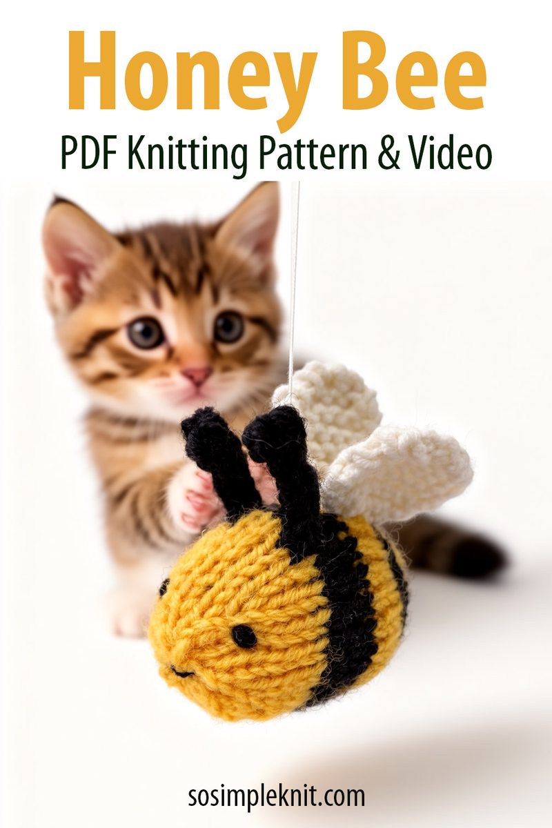 A knitted honey bee toy, primarily yellow with black stripes and small black wings, is suspended from a string in the foreground. In the background, a soft-focus, playful tabby kitten is reaching out towards the bee. The overall composition features a light, neutral background to emphasize the colorful bee and the kitten's curious expression. The top of the image has the text "Honey Bee PDF Knitting Pattern & Video" in bold green font.