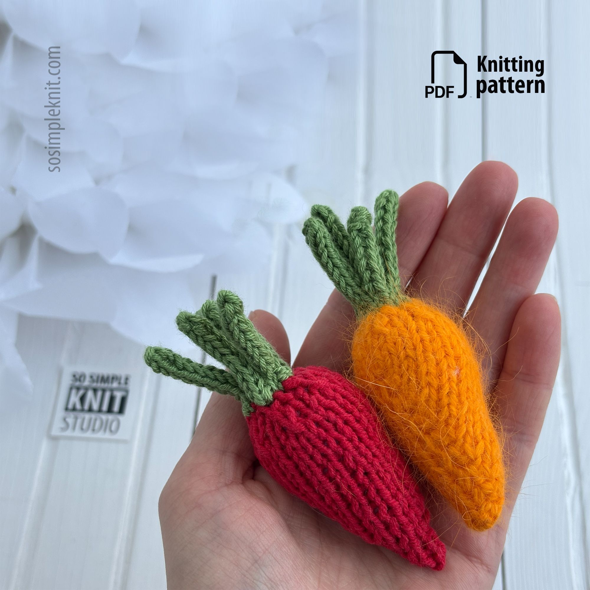 The photo shows a hand holding two colors of knitted carrots designed for decorating an Easter table. This is a knitting pattern for needle knitting