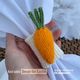 The photo shows a hand holding a knitted carrot napkin ring. The text on the image reads: “Easter table setting for your home. A step-by-step tutorial for beginner knitters.”