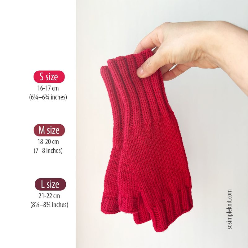 A hand is holding a pair of red fingerless gloves, showcasing a ribbed knitting pattern. To the left, there are three textual labels indicating sizes: S (16-17 cm), M (18-20 cm), and L (21-22 cm), each with their respective measurements in inches. The background is light and neutral, allowing the vibrant red of the gloves to stand out prominently.