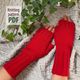 A pair of bright red fingerless gloves made from a textured yarn pattern is displayed on a soft, knitted ivory background. The gloves feature ribbed edges and openings for the fingers, showcasing a close-up view of the knit details. To the left, there is a graphic text overlay that reads "Knitting pattern PDF." In the background, green ivy leaves add a touch of nature to the scene. The overall composition emphasizes the gloves while highlighting the intricate knit design.