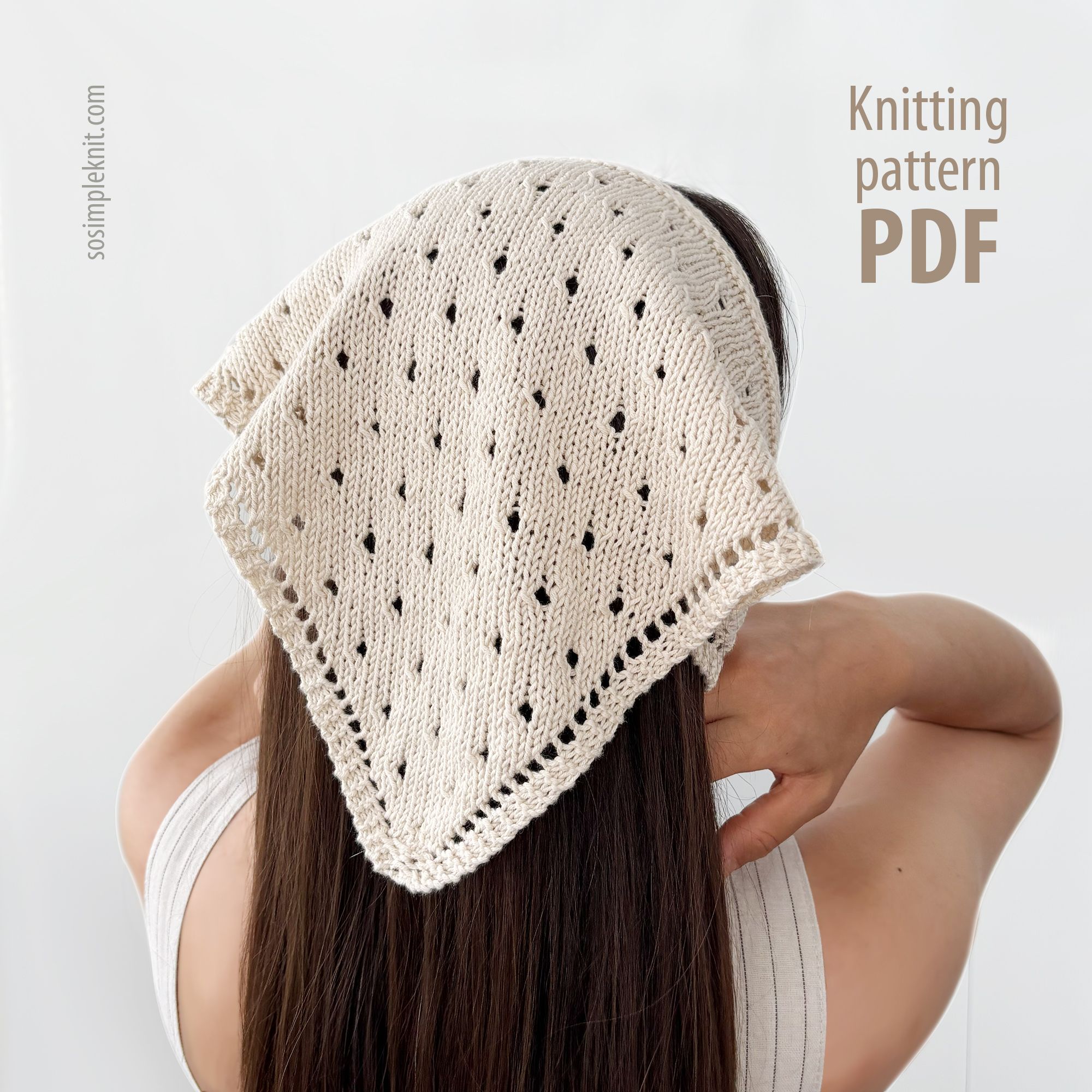 A woman with long brown hair is shown from behind, wearing a knitted triangular scarf positioned over her shoulders. The scarf is cream-colored with an intricate openwork pattern featuring small holes. The background is neutral, enhancing the focus on the scarf. Text on the right side reads "Knitting pattern PDF." The overall composition emphasizes the scarf's texture and design.