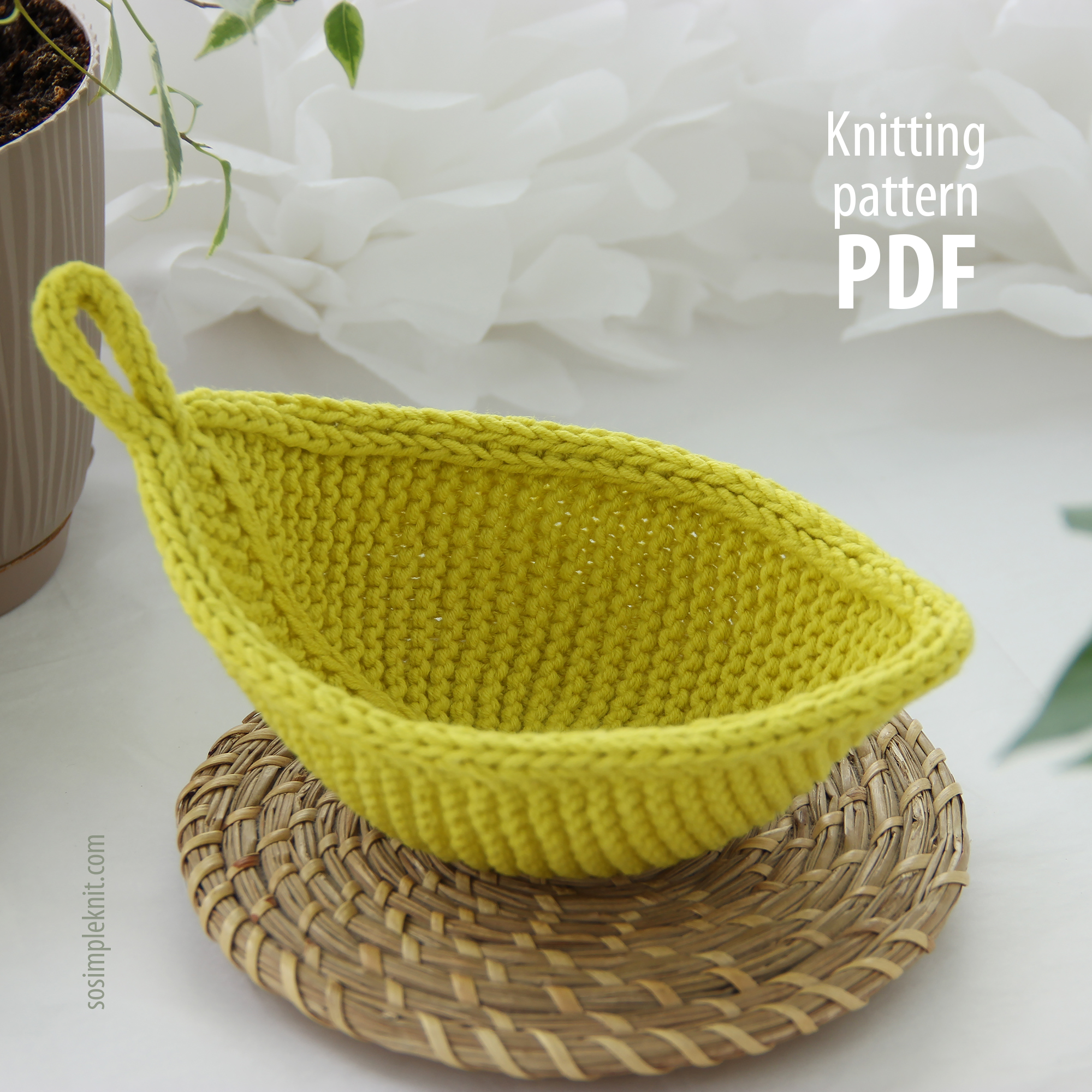 Light green knitted leaf coaster on a beautifully styled table, leaf-shaped hot pad, cozy kitchen decor, Leaf Coaster knitting pattern