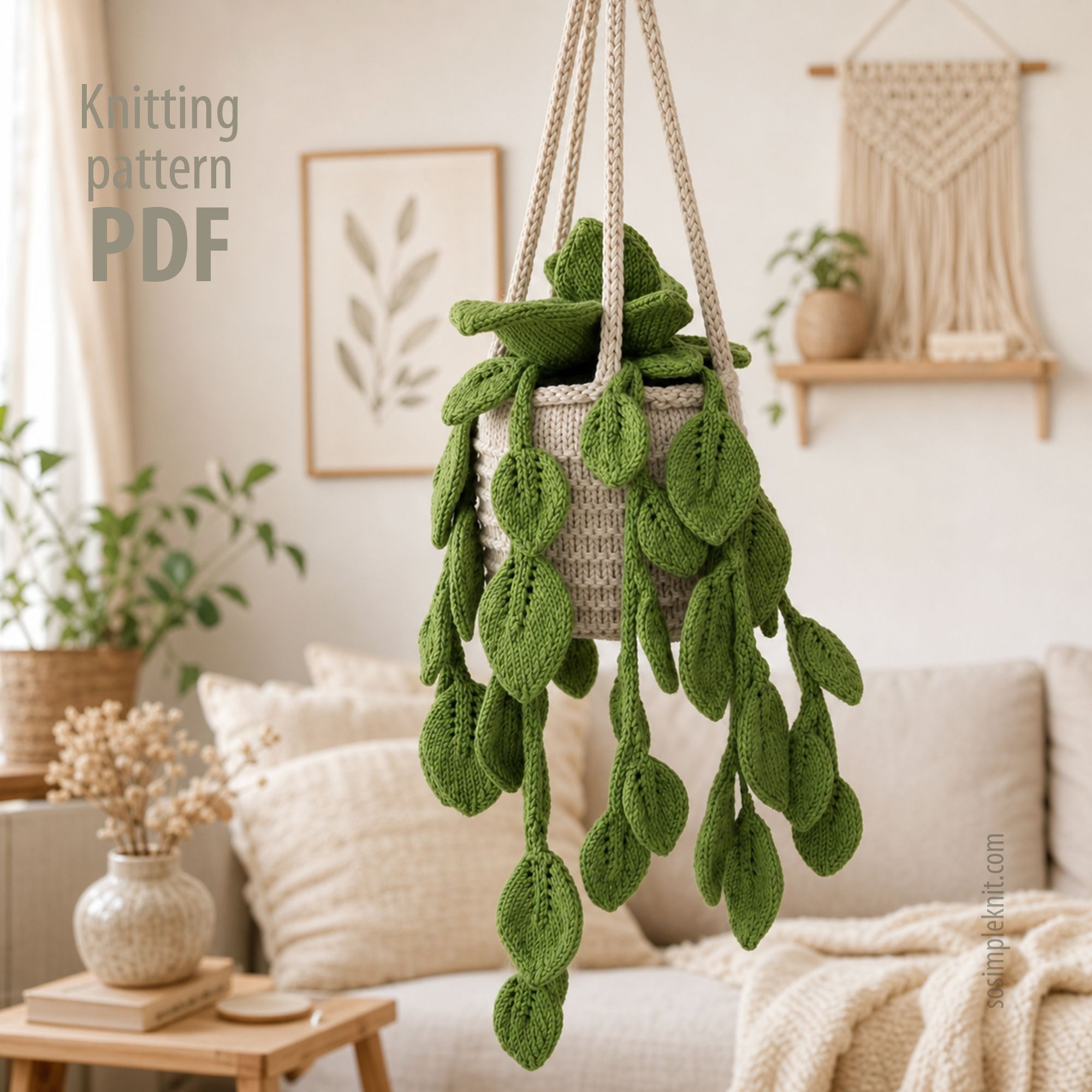 A knitted pothos plant hangs in a neutral-toned macrame planter, featuring vibrant green leaves cascading down. The background includes a light-colored couch with a textured throw pillow, a woven wall hanging, and decorative plants in the room, creating a cozy, inviting atmosphere. The text "Knitting pattern PDF" is partially visible in the upper left corner.