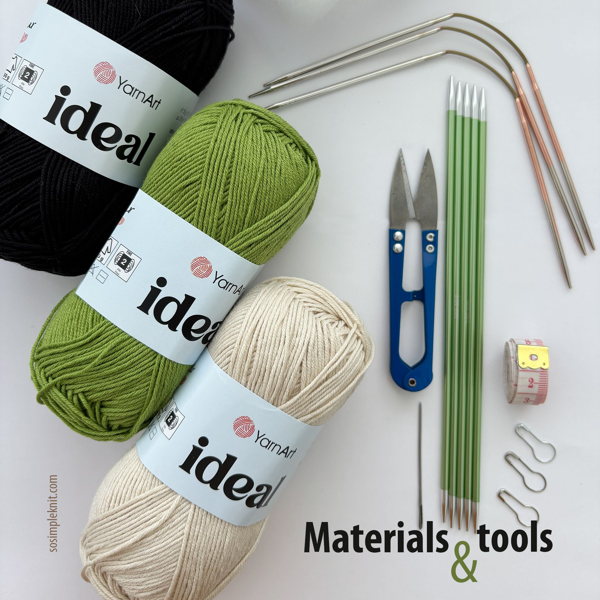 The image features three skeins of yarn in black, green, and cream, labeled "ideal" by YarnArt, arranged at the bottom. Above the yarn, there are knitting needles in various sizes, including green plastic and metal options, along with a pair of scissors, a tape measure, and several stitch markers. The elements are neatly organized against a white background, with the text "Materials & tools" prominently displayed in bold black font.