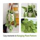 The image displays a knitted pothos hanging plant, featuring a cream-colored pot with a textured surface adorned with vibrant green leaves. The plant is suspended with three cords, giving it a cascading appearance. In the background, a wooden guitar partially shows, adding a rustic touch. The leaves vary in size and are intricately crafted to resemble real pothos foliage, showcasing a natural representation. The overall style is cozy and inviting, with a light color palette creating a warm atmos