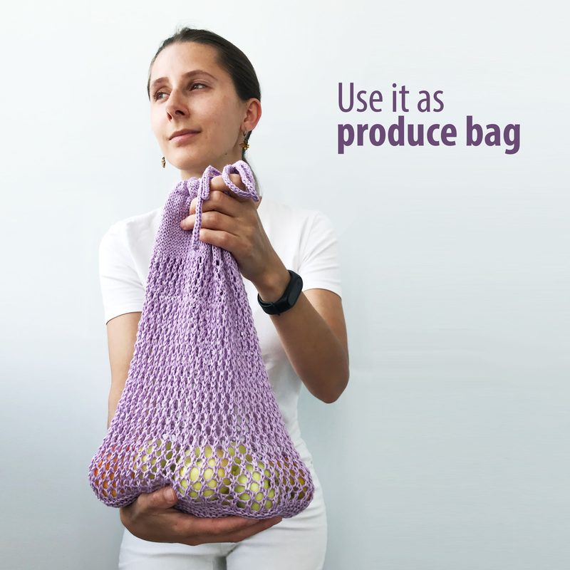 A woman in a white shirt holds a light purple knitted produce bag filled with round white items. She gazes thoughtfully to the side, and the bag is cinched at the top with a loop. The background is minimalistic, and the text "Use it as produce bag" is positioned to the right in a bold purple font. The overall composition focuses on the woman and the produce bag, highlighting the bag's texture and functionality.