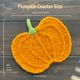 The image features a knitted pumpkin coaster, showcasing a vibrant orange color with textured ridges resembling pumpkin lines. The coaster has a small green knitted stem at the top, and it is laid flat against a dark wooden surface. Measurements are indicated next to the coaster in white text, displaying approximate sizes of 18.5 cm (7.5 inches) and 15.5 cm (6 inches). The overall composition is centered with the pumpkin coaster prominently featured in the foreground.