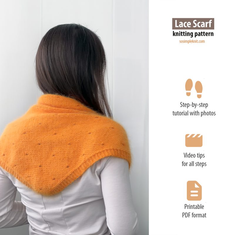 A person stands facing away, wearing an orange lace triangle scarf draped around their shoulders. The scarf features a delicate, openwork design with two textured patterns. The background is plain and white, providing a clean contrast to the scarf's vibrant color. The person’s hair is long and dark, and the focus is primarily on the scarf. Text on the image indicates additional resources for the knitting pattern.