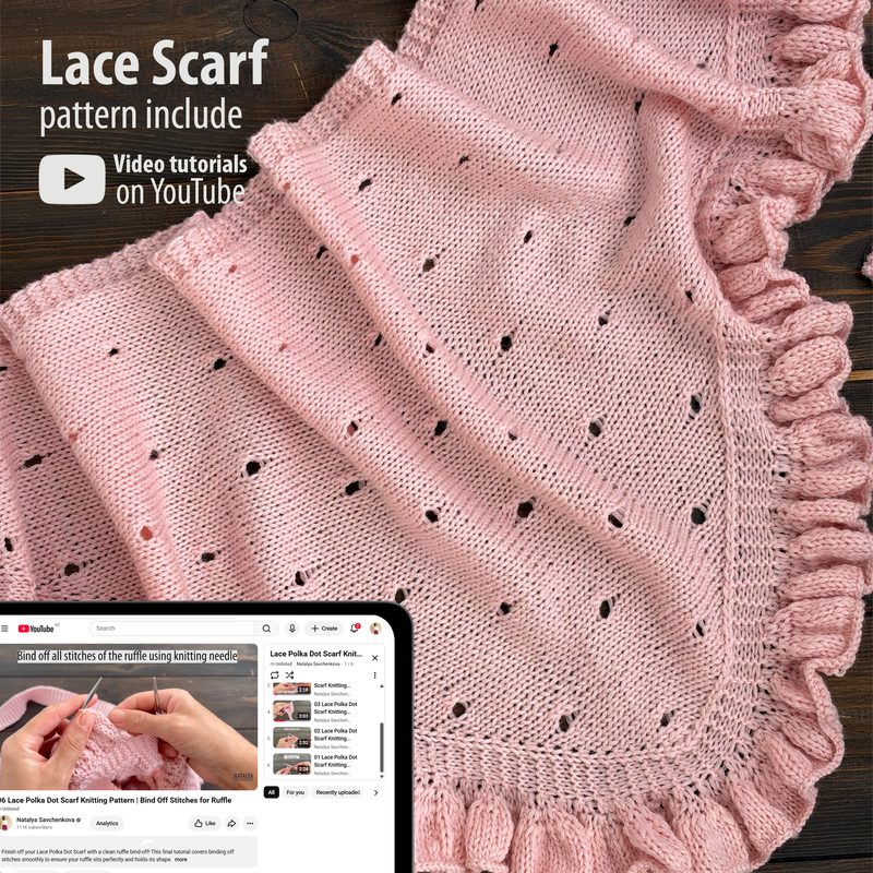 The image features a light pink lace triangle scarf displayed on a wooden surface, showcasing an intricate knitted pattern with small holes throughout. There is a decorative ruffled edge along one side of the scarf. In the bottom left corner, a digital device displays a knitting tutorial video related to the scarf pattern, with visible text instructing viewers on the technique. The overall composition is warm and inviting, emphasizing the texture of the knit fabric.