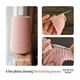 The image features a light pink yarn cone held in a hand, alongside two smaller images of a knitting project in progress. One close-up shows a pink knitted piece on needles with a lace pattern, and another image displays the same piece with more detail. The overall color scheme is soft pastels, mainly light pink and beige, with a natural, cozy aesthetic. The photos are framed cleanly to focus on the knitting process.